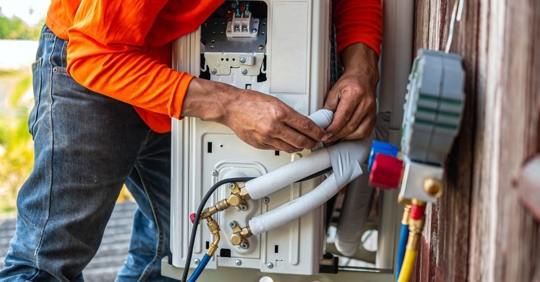 technician working on AC compressor