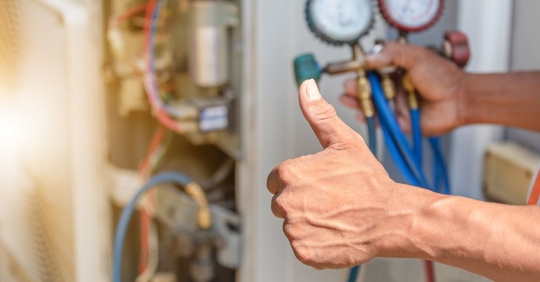 thumbs up in front of HVAC system
