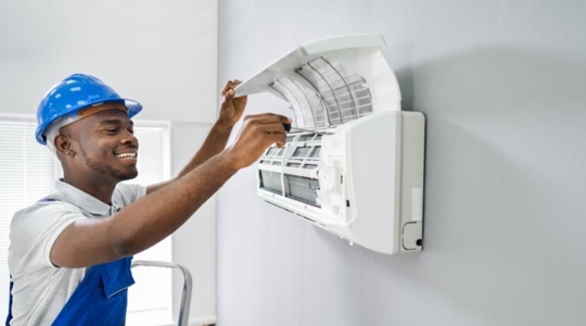 technician cleans the filter in a ductless unit