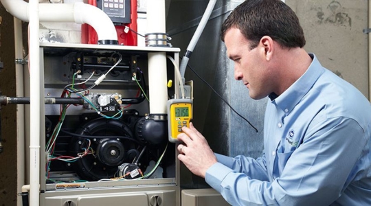 technician works on an hvac unit