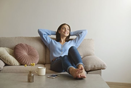 woman relaxes on a couch